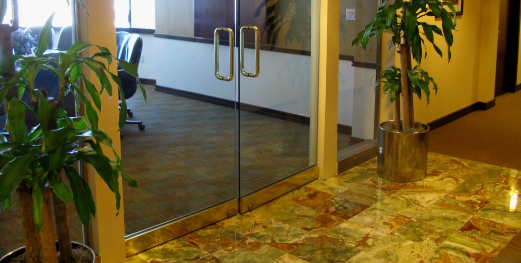 WARM AND TEXTURAL MATERIALS are conducive to relaxation in this office lobby.